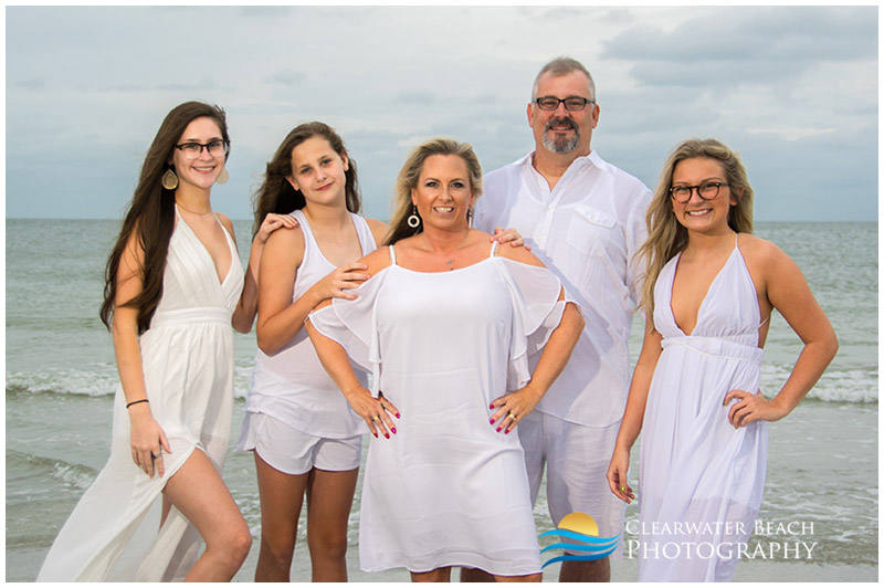 family in front of cloudy sky on Sand Key Beach