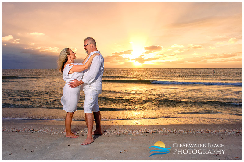 photo of couple in front of sunset on clearwater Beach