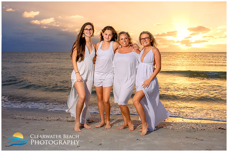 photo of mother with daughters in front of sunset on clearwater beach