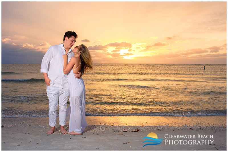 photo of young couple in front of sunset on clearwater beach