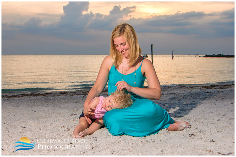 Toddler sleeping on Florida moms lap on Clearwater Beach